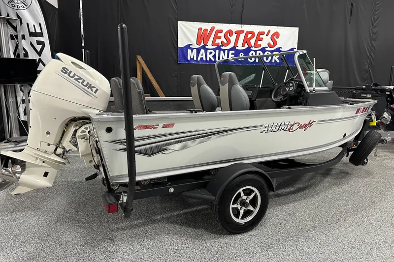 Slide: The Image of 2020 Alumacraft Classic 165 Sport boat with Suzuki outboard motor on display. - 2