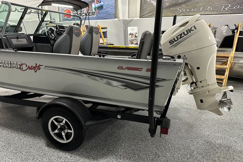 Slide: The Image of 2020 Alumacraft Classic 165 Sport boat with Suzuki outboard motor in showroom. - 4