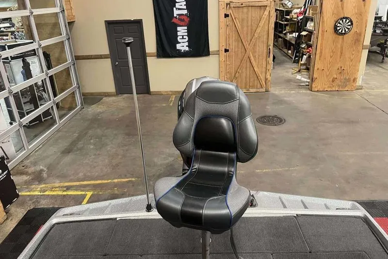 Slide: The Image of 2016 Ranger Z175 boat seat in a garage setting with wooden doors and dartboard. - 6