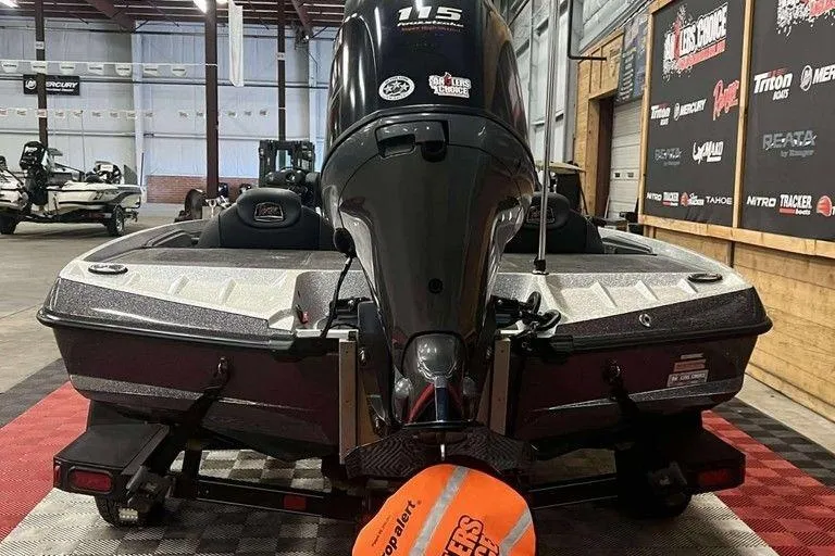 Slide: The Image of 2016 Ranger Z175 boat with 115 HP engine in a showroom setting. - 8