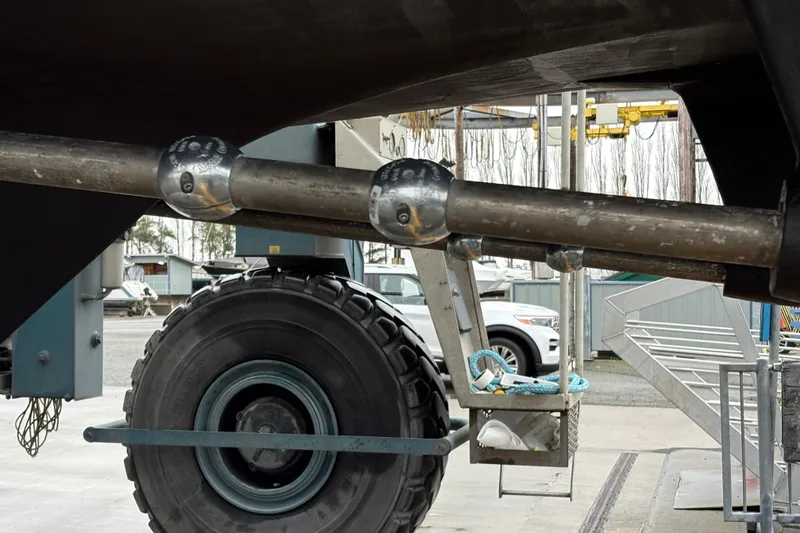 Slide: The Image of 1993 Ocean Alexander 423 Classico boat propeller shaft and anodes in a shipyard. - 13
