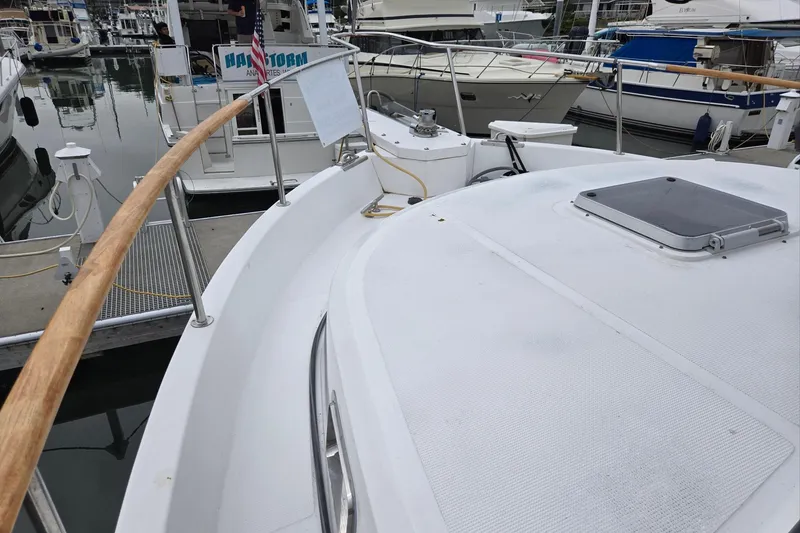 Slide: The Image of 1993 Ocean Alexander 423 Classicco yacht docked at marina, showcasing deck and railing. - 2