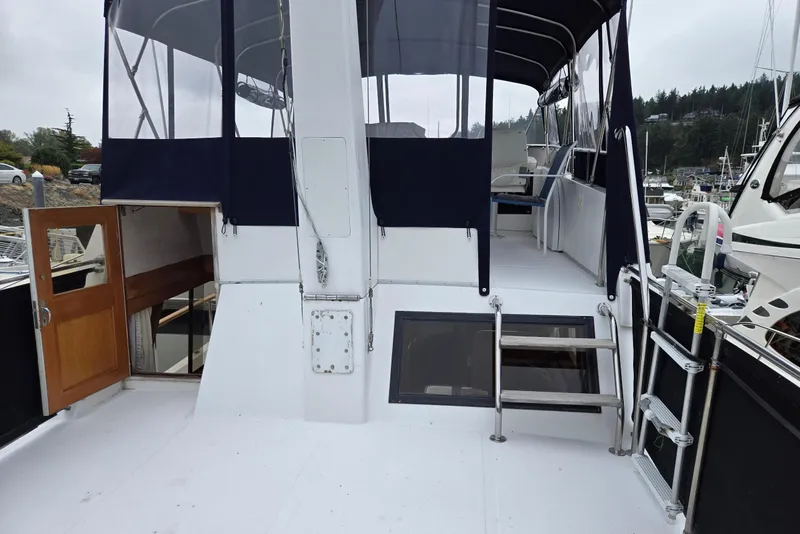 Slide: The Image of 1993 Ocean Alexander 423 Classicco yacht deck with canopy and open cabin door. - 23