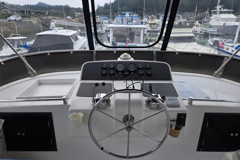 Slide: The Image of Cockpit view of 1993 Ocean Alexander 423 Classicco yacht in a marina setting. - 27