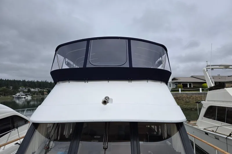 Slide: The Image of 1993 Ocean Alexander 423 Classicco yacht docked under cloudy skies. - 3
