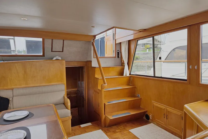 Slide: The Image of Interior of 1993 Ocean Alexander 423 Classicco yacht with wooden stairs and seating area. - 33