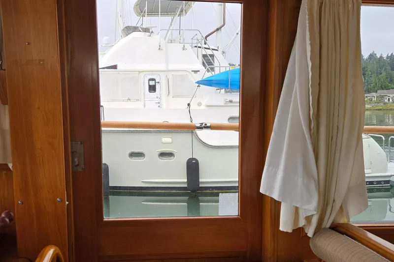 Slide: The Image of View from inside a 1993 Ocean Alexander 423 Classicco, looking out at a docked boat. - 36
