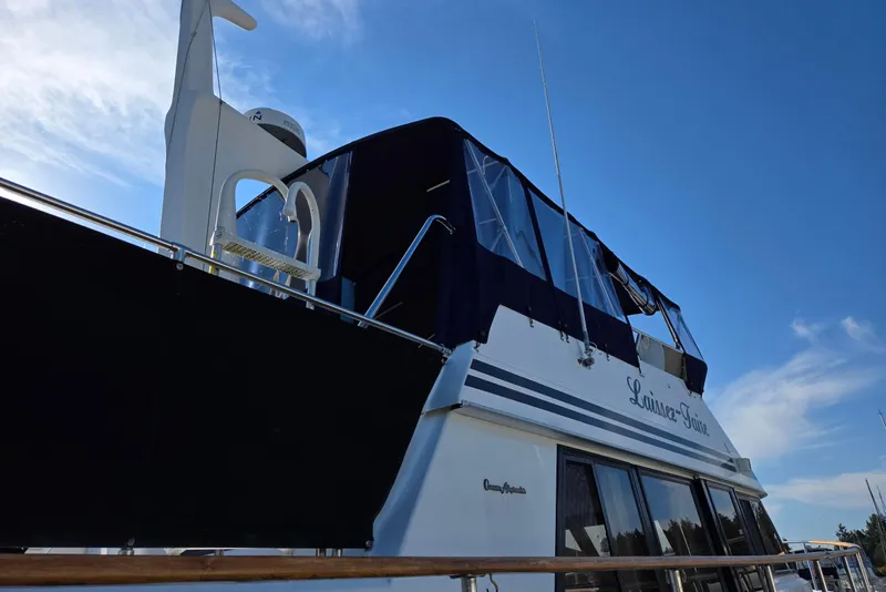 Slide: The Image of Ocean Alexander 423 Classicco yacht, 1993 model, with blue canopy under clear sky. - 5