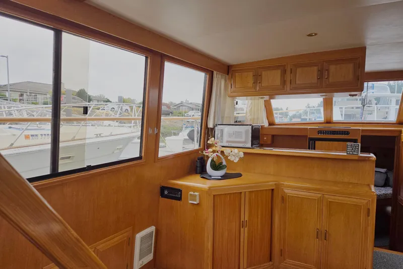 Slide: The Image of Interior of 1993 Ocean Alexander 423 Classicco yacht with wooden cabinetry and large windows. - 62