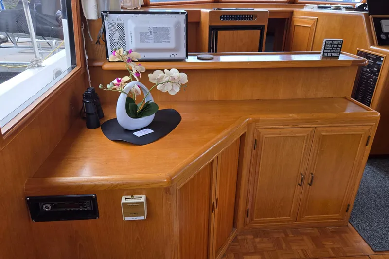 Slide: The Image of Interior of 1993 Ocean Alexander 423 Classicco with wooden cabinetry and decorative orchid. - 63
