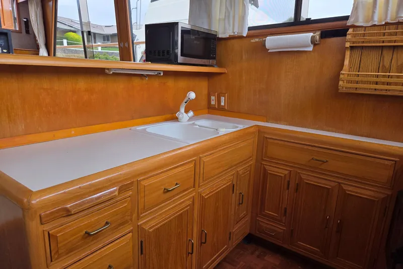 Slide: The Image of 1993 Ocean Alexander 423 Classicco yacht kitchen with wooden cabinets and countertop. - 65