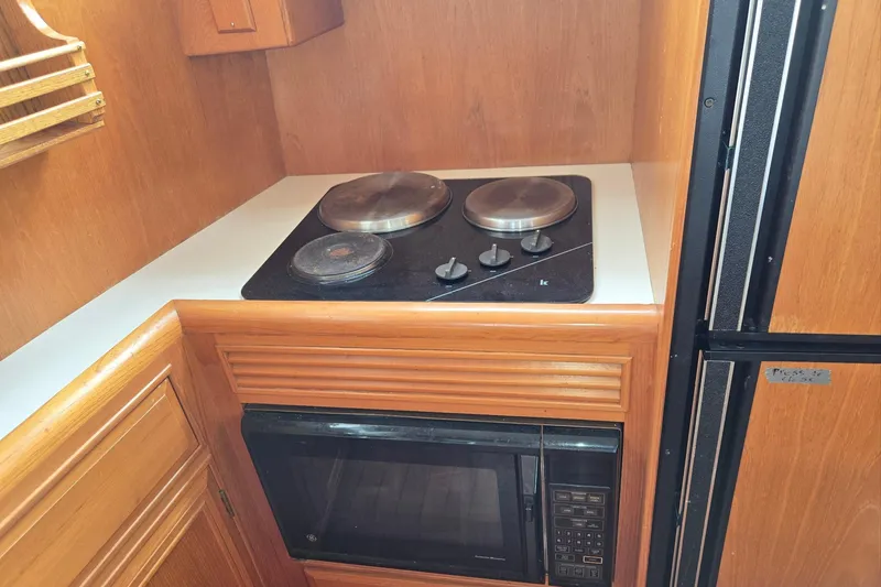 Slide: The Image of Compact kitchen area in a 1993 Ocean Alexander 423 Classicco yacht with stove and microwave. - 67