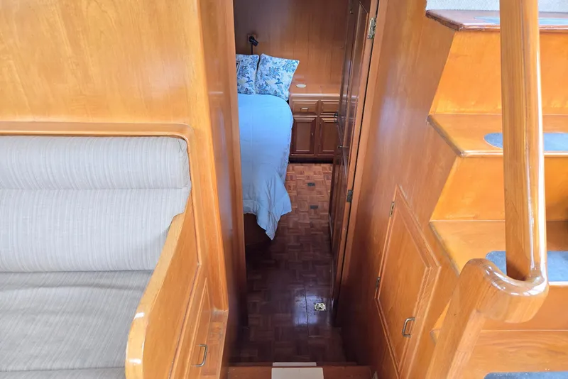 Slide: The Image of Interior of 1993 Ocean Alexander 423 Classicco yacht, featuring wooden stairs and cozy cabin. - 76