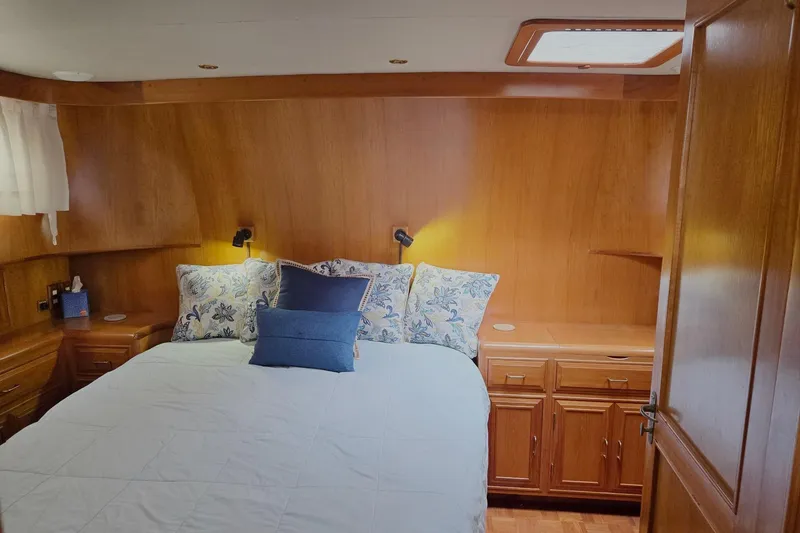 Slide: The Image of Cozy bedroom in 1993 Ocean Alexander 423 Classicco yacht with wood paneling and floral pillows. - 79
