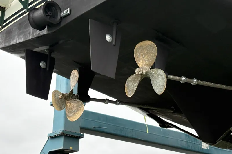 Slide: The Image of Propellers and rudders of a 1993 Ocean Alexander 423 Classico yacht in dry dock. - 12