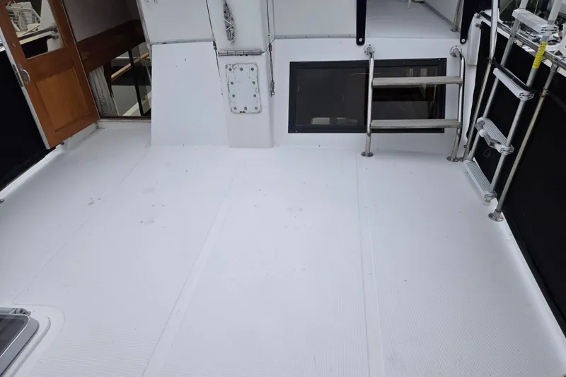 Slide: The Image of 1993 Ocean Alexander 423 Classicco yacht deck with ladder and wooden door. - 24