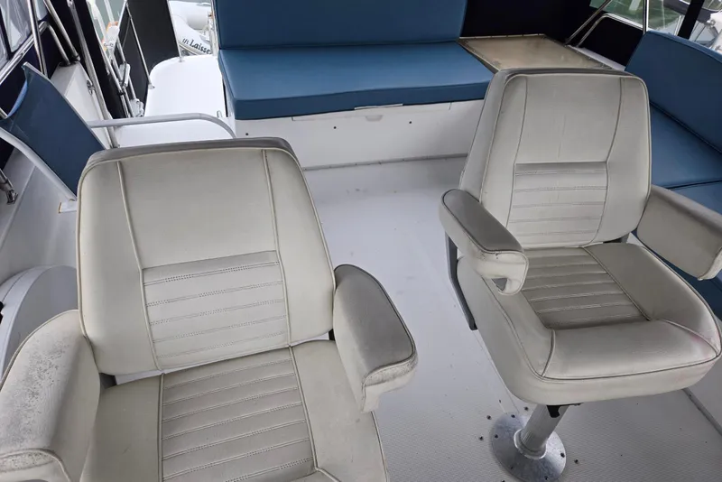 Slide: The Image of 1993 Ocean Alexander 423 Classicco interior with white seating and blue cushions. - 29