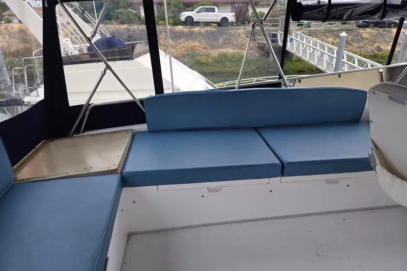 Slide: The Image of 1993 Ocean Alexander 423 Classicco yacht interior with blue seating and marina view. - 30