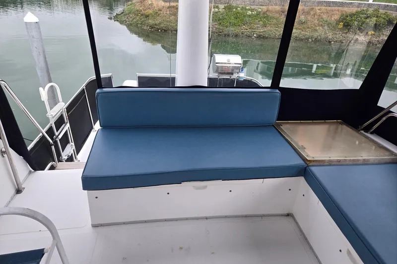 Slide: The Image of 1993 Ocean Alexander 423 Classicco yacht interior with blue seating and water view. - 31