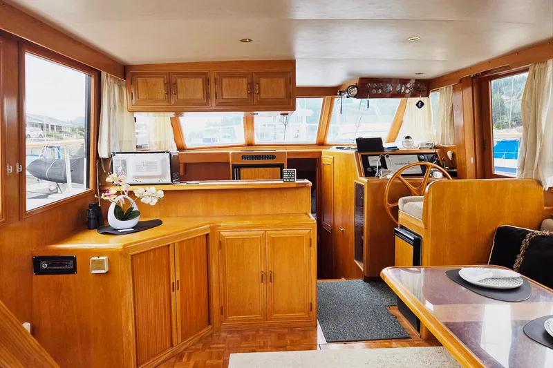 Slide: The Image of Interior of 1993 Ocean Alexander 423 Classicco yacht, featuring wooden cabinetry and helm station. - 34