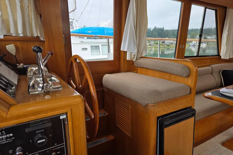 Slide: The Image of Interior of 1993 Ocean Alexander 423 Classicco yacht with wooden helm and seating area. - 35