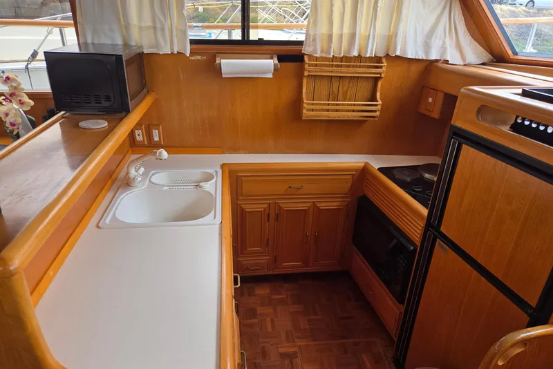 Slide: The Image of 1993 Ocean Alexander 423 Classicco yacht kitchen with wood cabinetry and modern appliances. - 64