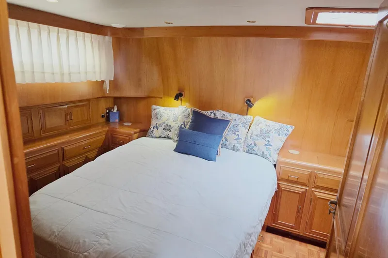 Slide: The Image of Luxurious 1993 Ocean Alexander 423 Classicco yacht bedroom with wood paneling and cozy bedding. - 77