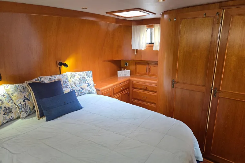 Slide: The Image of Cozy bedroom in 1993 Ocean Alexander 423 Classicco yacht with wooden interior and plush bedding. - 80