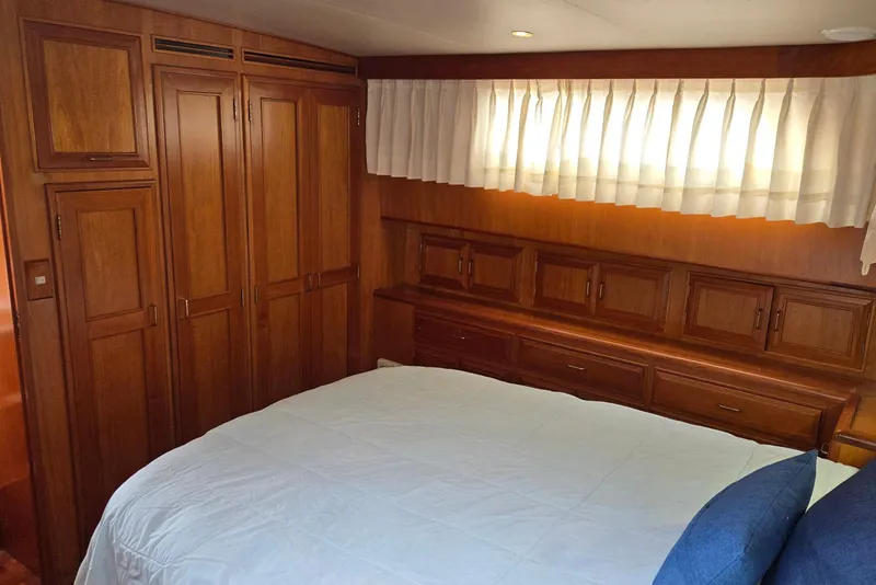 Slide: The Image of Luxurious 1993 Ocean Alexander 423 Classicco yacht bedroom with wooden cabinetry and cozy bedding. - 82