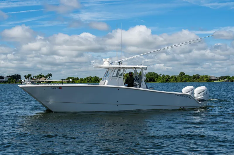 The Image of 2022 Freeman 34VH boat cruising on a lake under a partly cloudy sky. - 0