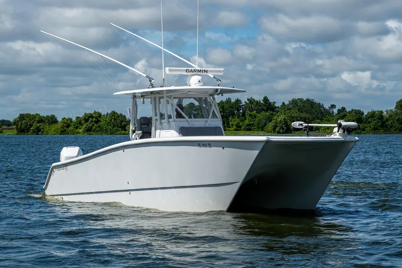 Slide: The Image of 2022 Freeman 34VH boat on water, featuring Garmin equipment, under cloudy sky. - 1