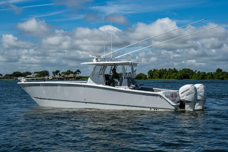 Slide: The Image of 2022 Freeman 34VH boat on a lake under a partly cloudy sky. - 12