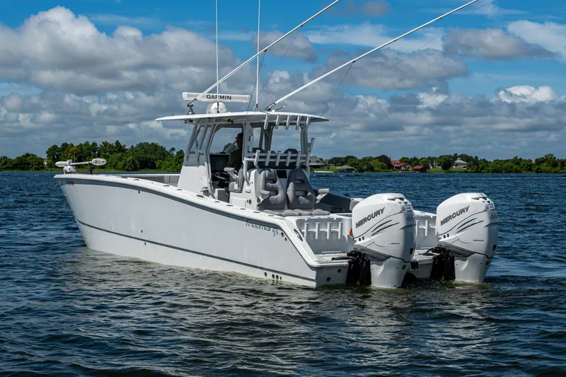 Slide: The Image of 2022 Freeman 34VH boat with twin Mercury engines on a calm lake. - 14