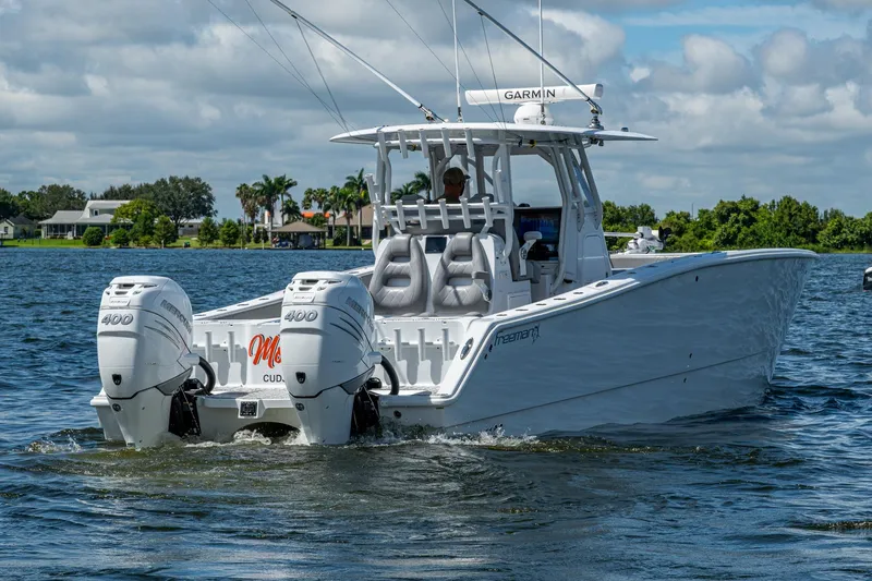 Slide: The Image of 2022 Freeman 34VH boat with twin Mercury 400 engines on a sunny day. - 17