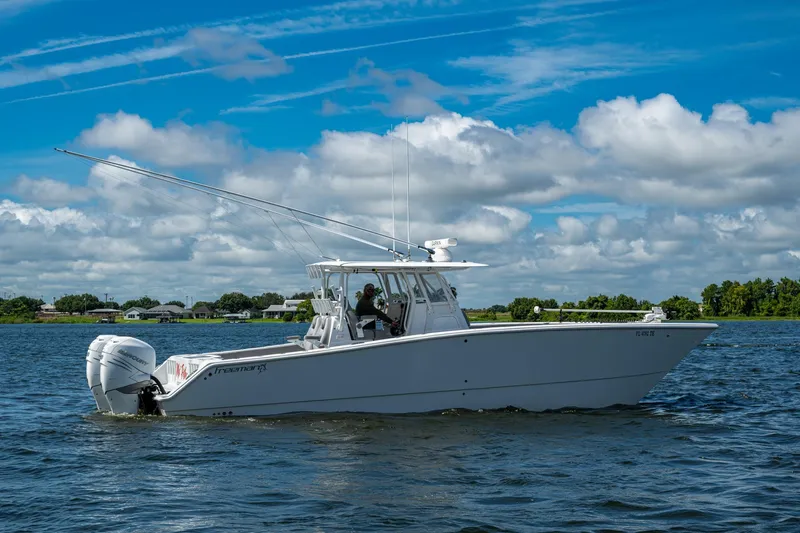 Slide: The Image of 2022 Freeman 34VH boat cruising on a sunny day with blue skies and clouds. - 19