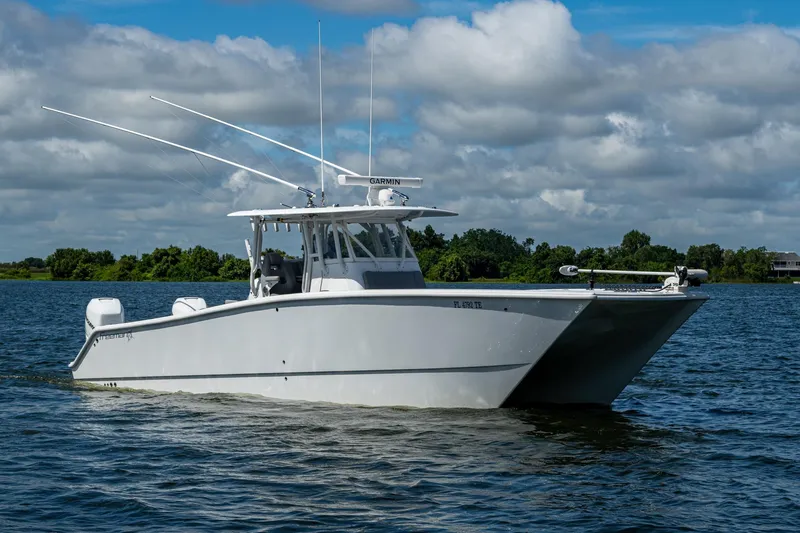 Slide: The Image of 2022 Freeman 34VH boat on a calm lake under a cloudy sky. - 2