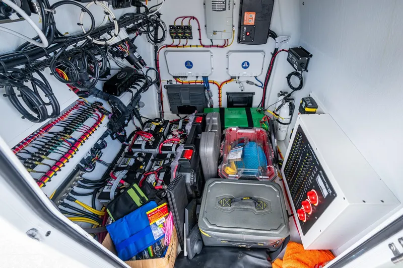 Slide: The Image of Electrical compartment of a 2022 Freeman 34VH boat, showcasing organized wiring and equipment. - 21