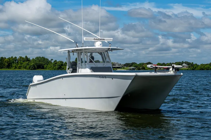 Slide: The Image of 2022 Freeman 34VH boat cruising on a lake under a partly cloudy sky. - 3