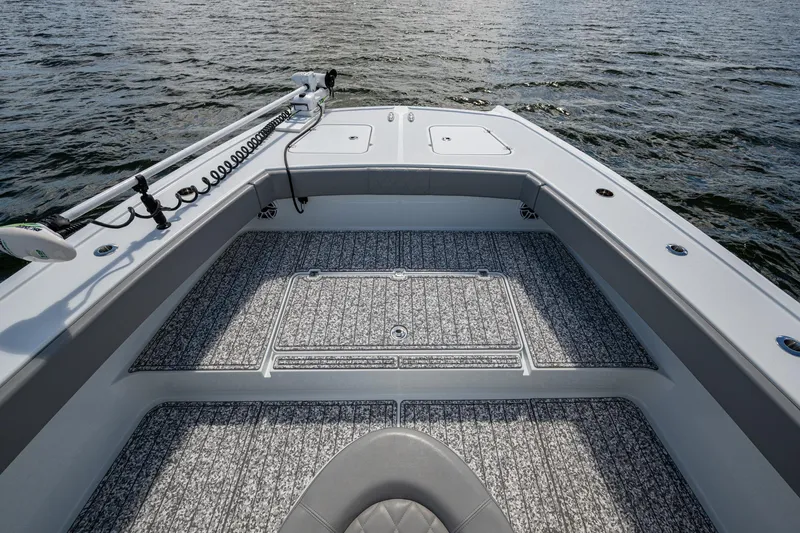 Slide: The Image of Bow view of 2022 Freeman 34VH boat on water, featuring spacious deck and trolling motor. - 33