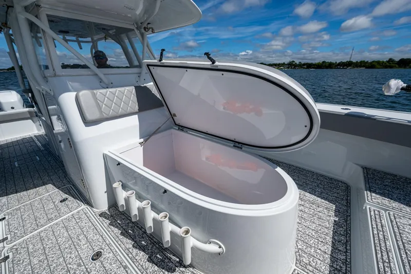 Slide: The Image of 2022 Freeman 34VH boat with open storage compartment on deck, under clear blue sky. - 40