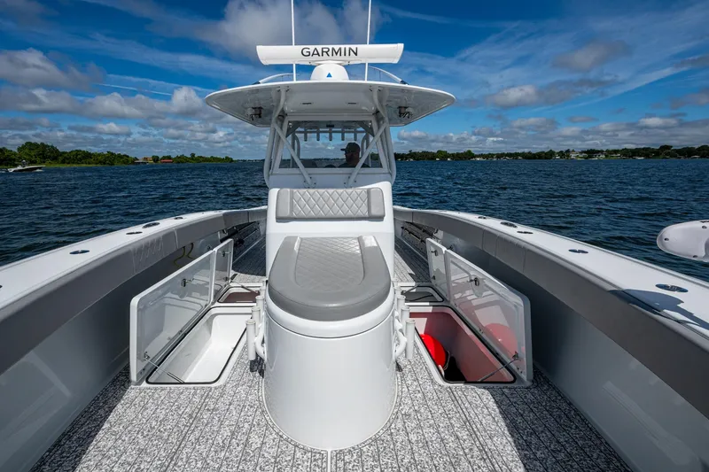 Slide: The Image of 2022 Freeman 34VH boat with open storage compartments on a sunny day. - 41