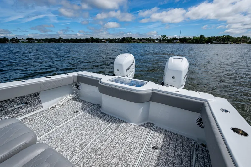 Slide: The Image of 2022 Freeman 34VH boat with dual engines on a calm lake under a blue sky. - 45