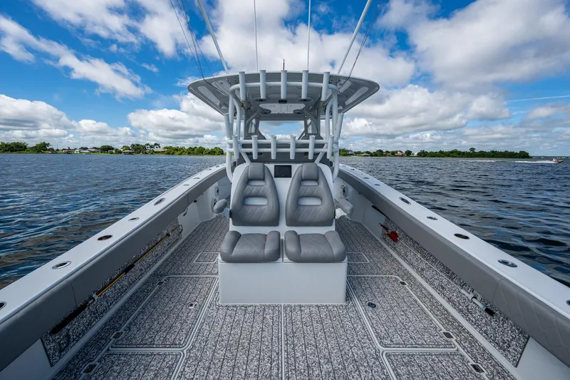 Slide: The Image of 2022 Freeman 34VH boat interior with dual seats on open water under blue sky. - 47