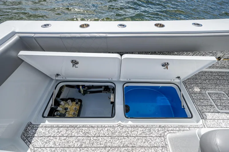 Slide: The Image of Open storage compartments on a 2022 Freeman 34VH boat, showing mechanical and water systems. - 50