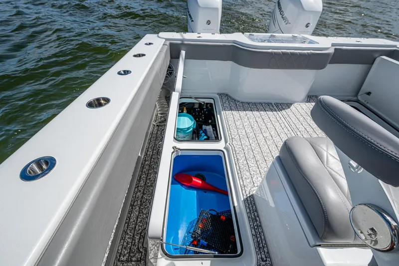 Slide: The Image of Freeman 34VH 2022 boat interior with storage compartments and seating on water. - 51