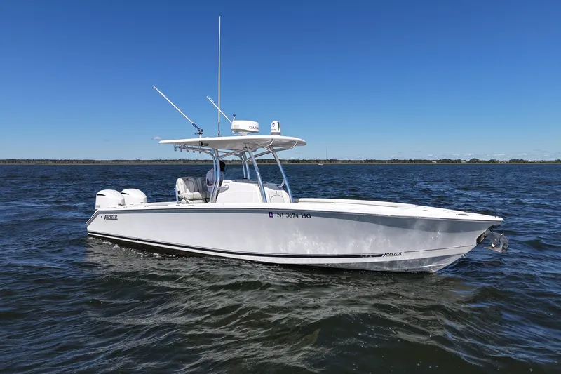 The Image of 2014 Jupiter 30 FS boat on open water under clear blue sky. - 0