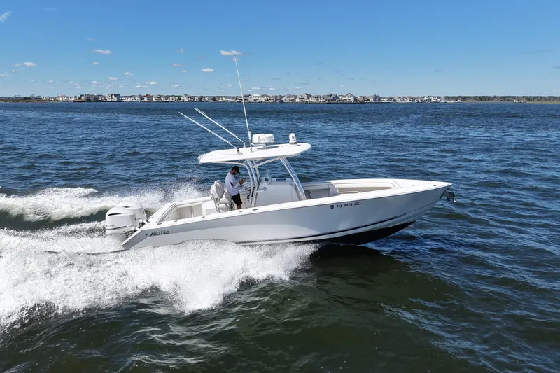 Slide: The Image of 2014 Jupiter 30 FS boat cruising on open water under clear blue skies. - 12