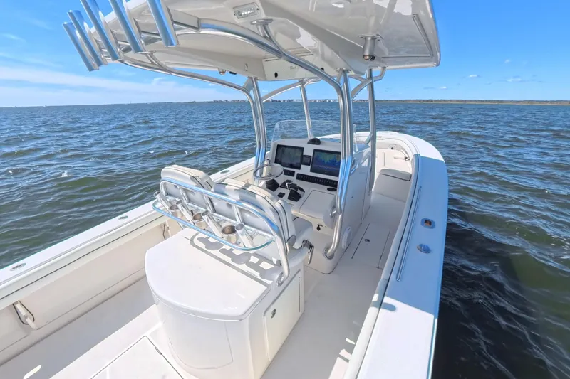 Slide: The Image of 2014 Jupiter 30 FS boat on open water, featuring modern helm and seating. - 15