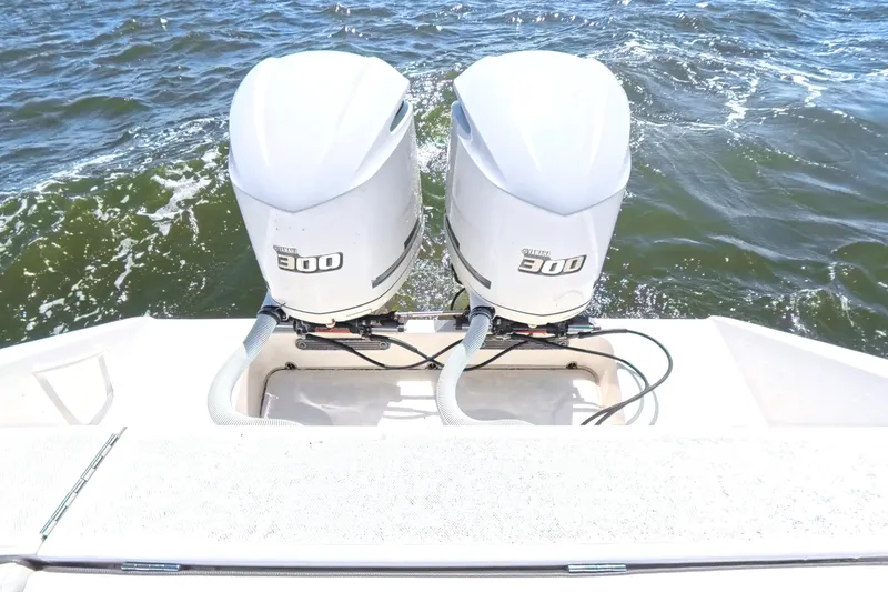 Slide: The Image of Twin Yamaha 300 engines on a 2014 Jupiter 30 FS boat in open water. - 17