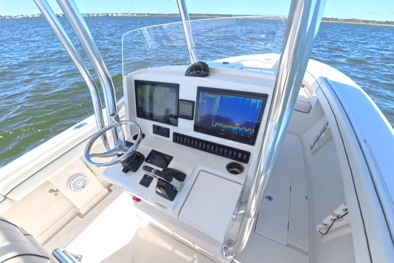 Slide: The Image of 2014 Jupiter 30 FS boat console with navigation screens on open water. - 19
